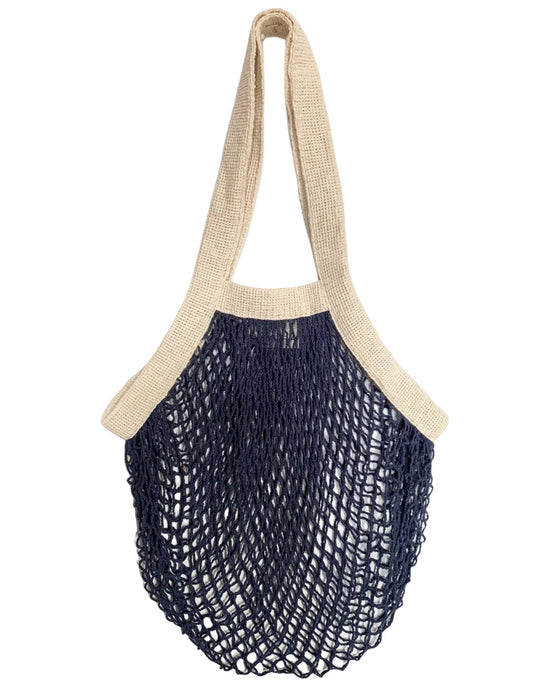 The French Market Bag No.2 In Navy by PILLOWPIA is a reusable organic cotton bag with beige handles and trim, and a navy blue open mesh body inspired by the classic French market bag.