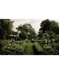 A lush garden scene from Flower Couture by Random House: neatly mowed grass paths, abundant flowering plants ideal for arranging, and trees frame a French country house partially visible on the left.