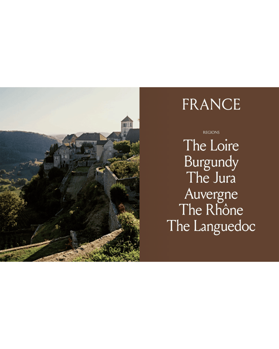 A sunset view of a French hilltop village with a brown panel featuring French wine regions famous for natural wine—The Loire, Burgundy, The Jura, Auvergne, The Rhône, and Languedoc—highlighted in Spilled Natural Winemakers Stories & Recipes by Random House.