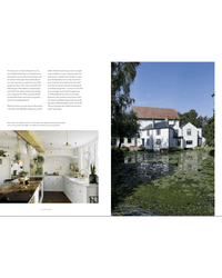 A two-page magazine spread features The deVOL Kitchen by Random House with lush plants on the left and a beautiful white house beside a lily pad pond on the right, showcasing elegant kitchen design and unique style.