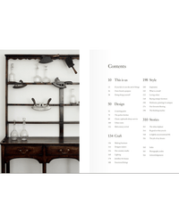 The deVOL Kitchen by Random House is displayed as a wooden cabinet with glass bottles and metal items on its shelves, next to a table of contents page listing various sections and their page numbers.