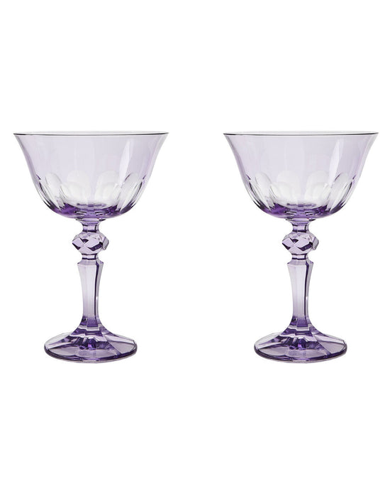 Two Rialto Glass Coupe Amethyst glasses by SIR / MADAM, each with faceted stems, are displayed side by side on a white background.