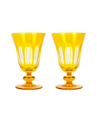 Two amber Rialto Glass Tulip Ginger goblets by SIR / MADAM, with clear vertical cut accents and round bases, stand side by side on a white background, highlighting Venetian-inspired design and timeless elegance.