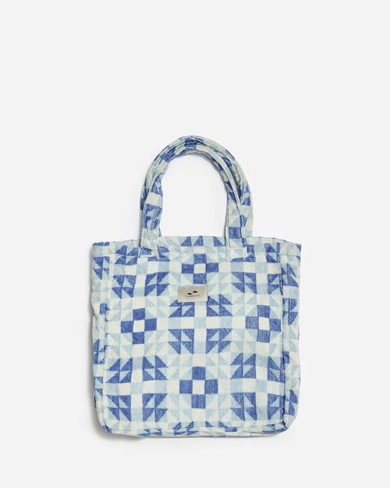The Dream Terry Tote Bag in Lagoon by Slowtide features a blue and white pattern, two handles, and a small front label. Made from sustainably sourced cotton, it’s set against a plain light background.