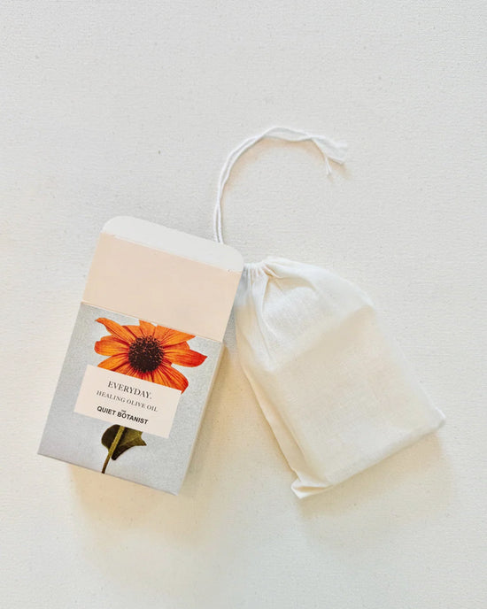 A box labeled Everyday - Handmade Soap by The Quiet Botanist sits next to a white drawstring pouch on a light surface—ideal for sensitive skin and featuring a gentle, natural fragrance.