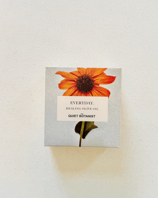 A square box with an orange flower on a light background, labeled Everyday. Handmade Soap by The Quiet Botanist—features natural fragrance and is perfect for sensitive skin.