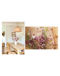 A bright kitchen featuring Flora Nouveaux by Chronicle Books—a sustainable floral design with modern dried flowers, displayed next to a wooden table, stools, and a brush for a contemporary touch.