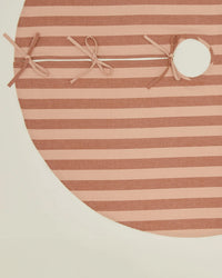 The Hawkins New York Essential Striped Tree Skirt in Blush/Terracotta features horizontal stripes, three tied bows, and a circular side opening, shown on a white background.