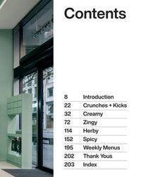 The Salad Project by Random House features a modern, minimalist table of contents page—black text on white lists sections like Introduction, Crunches + Kicks, and Spicy. A mint-green shelf and large window add cookbook-inspired style.