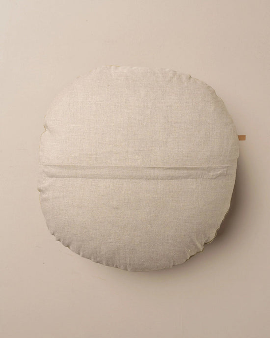 The Saarde Linen/Velvet Round Pillow with Feather Insert in Stone features a soft beige hue and subtle texture, displayed on a matching background.