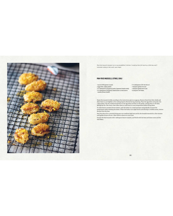 Breaded, pan-fried Mussels from Simon & Schuster cool on a black wire rack beside a cookbook page showing Sergio Hermans citrus and chili pan-fried mussels recipe.