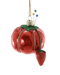 The Cody Foster Vintage Pin Cushion Ornament is a hand-crafted glass decoration resembling a shiny red tomato with green glittery leaves, a small red strawberry, colorful pins, and a gold hanging string—a unique holiday accent.