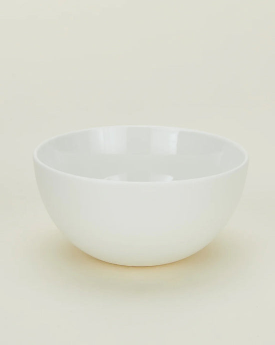 A set of four Simple Porcelain Large Bowls by Hawkins New York is displayed on a light neutral surface with a minimal, uncluttered background.
