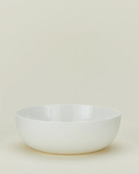 The Hawkins New York Simple Porcelain Serving Bowl, with smooth, clean lines, sits empty on a light, neutral background.
