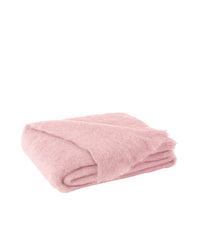 The Brushed Mohair Throw in Lotus by Lands Downunder, woven in New Zealand, features a soft, fluffy texture and is shown neatly folded in light pink against a white background.