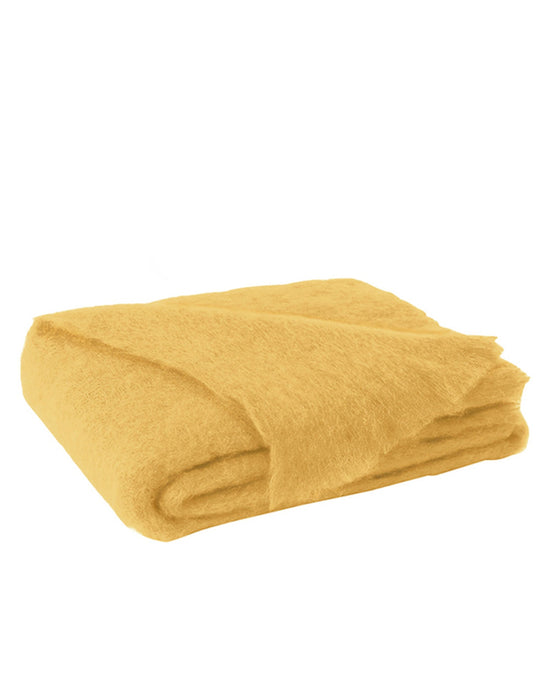 The Brushed Mohair Throw in Ochre by Lands Downunder, featuring a soft and fuzzy texture, is elegantly folded on a white background—an ideal luxury accent blanket woven in New Zealand.