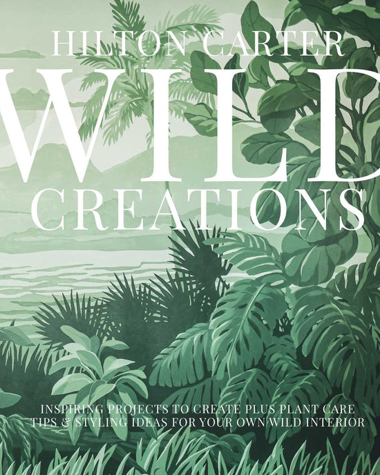 The book cover for Wild Creations by Simon & Schuster features illustrated tropical plants, a jungle landscape, and lush mountains—an inspiring scene for wild plant care and creative DIY projects.
