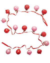 The creativeco-op Mercury Glass 2in Ornament Garland, Pink/Red on Velvet, features alternating red and pink vintage-style ornaments on a velvet ribbon, arranged in a zigzag pattern for charming holiday decor.